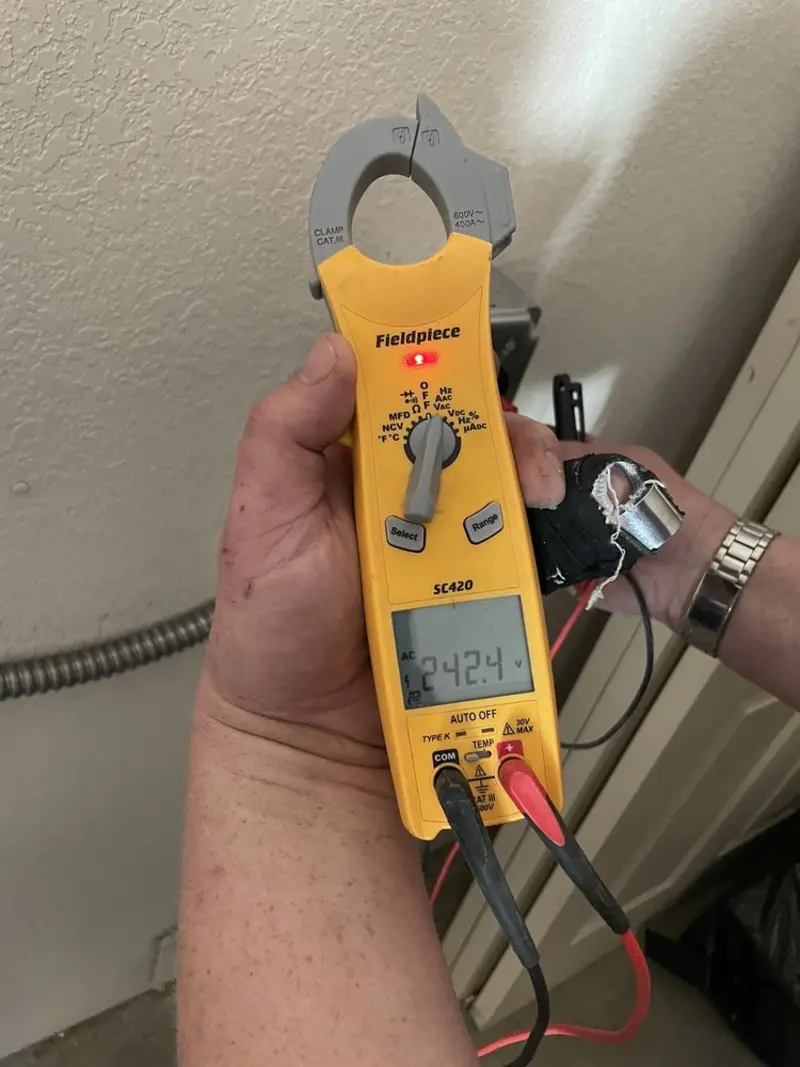 Voltage testing with clamp meter during Whole House Surge Protector in Harmony